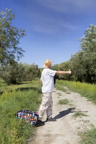 Young adult man tourist on rural road — Stock Photo, Image