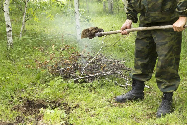 Forest firefighters conduct exercises to prevent a fire in the forest. Firemen put out fire in the forest. Firefighters close the ground where the fire in the forest was burning.