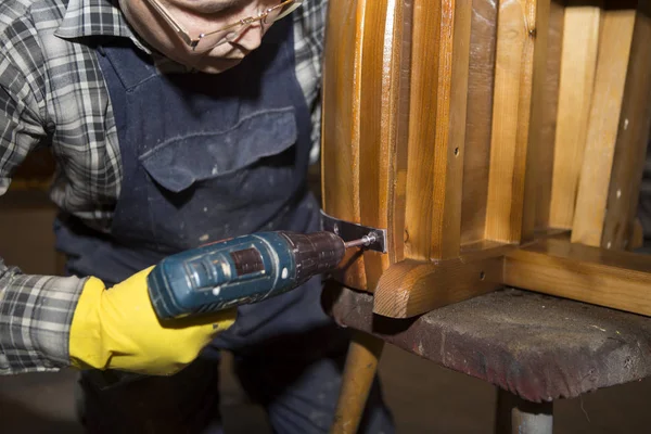 Making a wooden barrel. Cooperage worker assembled wooden barrels. A collector of a wooden barrel in a carpentry workshop. Cooperage