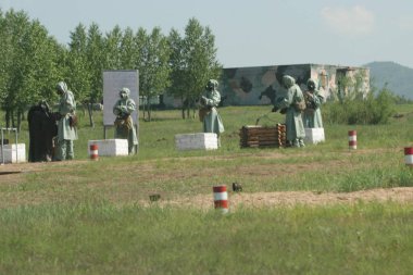 The tank training ground in Eastern Siberia. The military exercises of the tank brigade in a situation close to the battle in Russia. Gas attack. clipart