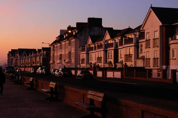 Seafront street with houses at sunset in Seaford, United Kingdom.