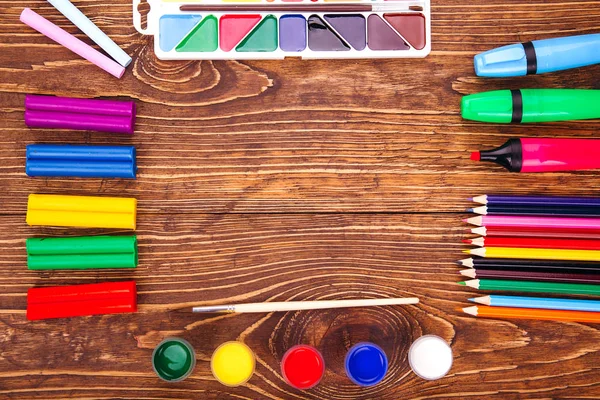 Frame of school supplies over a  retro wooden background. With c — Stock Photo, Image