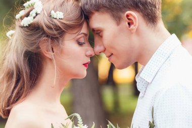 Mutlu genç yeni evli çift alınlarına ve burun park içinde dokunmadan