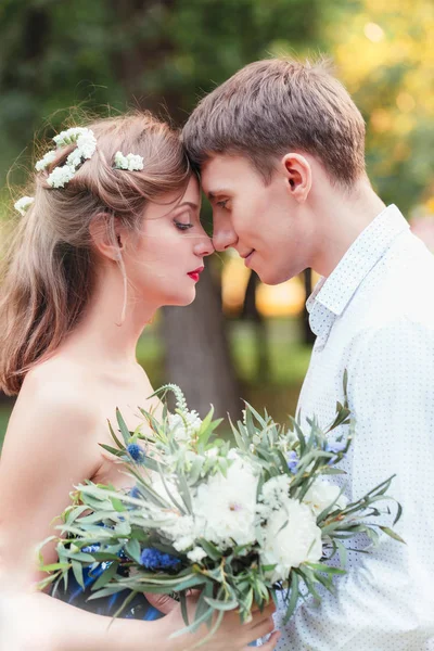 Gelukkig jonge jonggehuwde paar touching voorhoofd in park. Bedrijf — Stockfoto