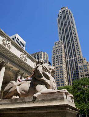 little girl on the lion statue at the entrance to the New York Public Library clipart