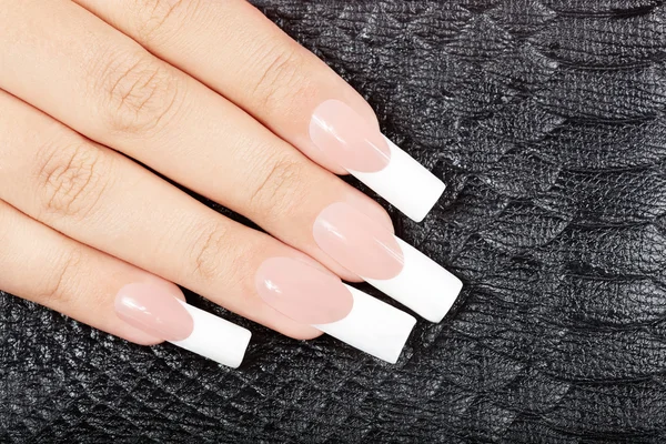 Hand with long artificial french manicured nails — Stock Photo, Image