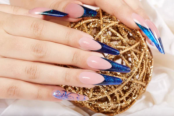 Hands with long artificial blue french manicured nails