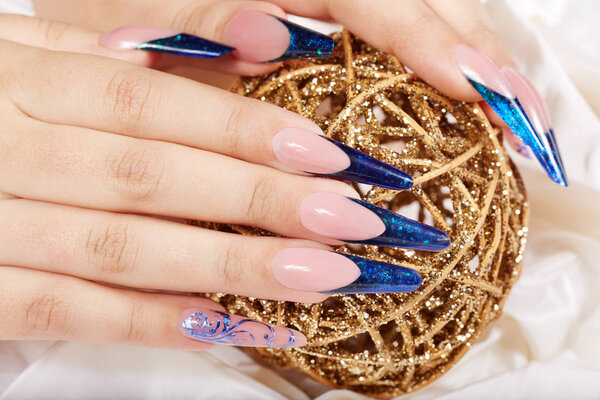 Hands with long artificial blue french manicured nails 