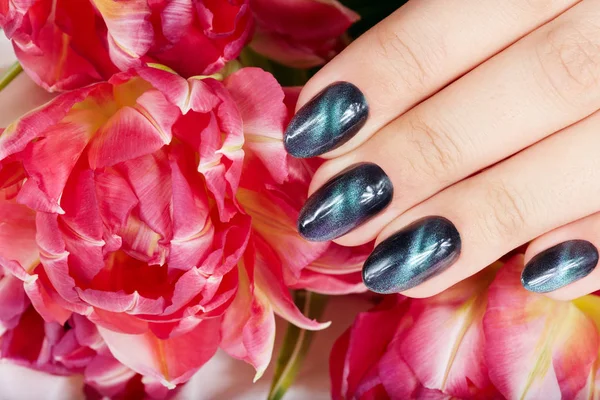 Hand Mit Gepflegten Nägeln Mit Katzenaugen Design Und Rosa Tulpenblüten — Stockfoto