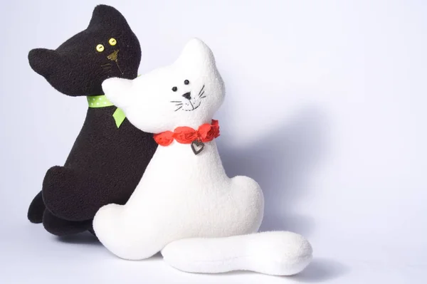 two toys of cat couple, black and white, white background