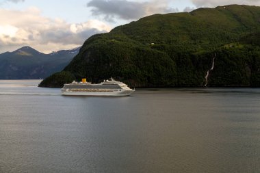 Cruiser ship in fjord, Norway. Luxury cruise ship at norwegian fjord