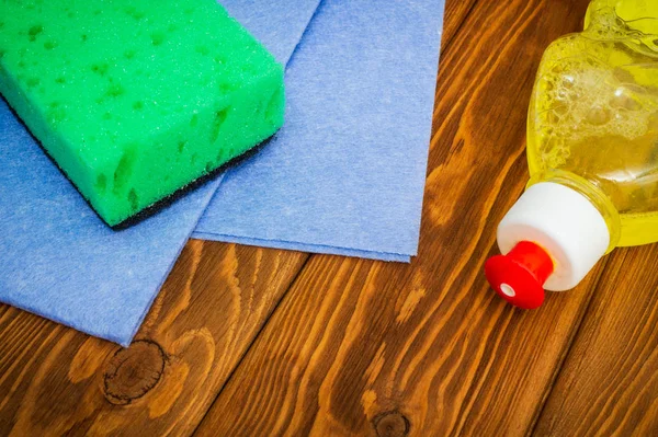 Liquid detergent with pad and towels for cleaning on wooden boards