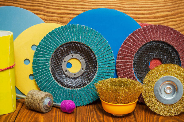 Set of abrasive tools and sandpaper on vintage wooden background
