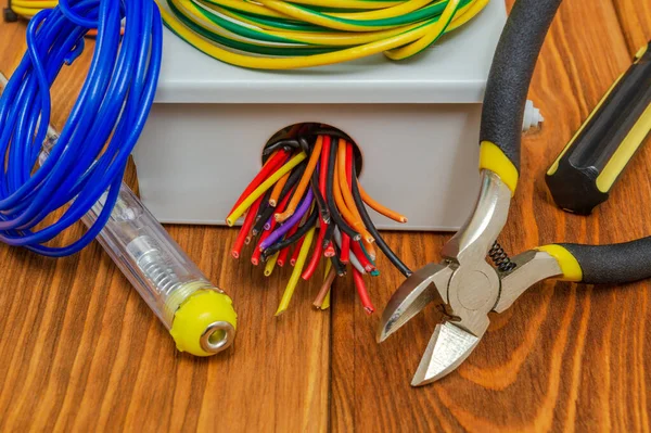 Caja de conexiones eléctricas con cables y herramientas utilizadas en el proceso de instalación eléctrica — Foto de Stock
