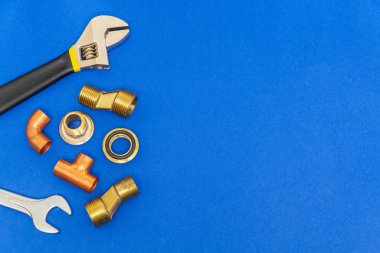 Set of tools for plumbing isolated on blue background with space for advertising