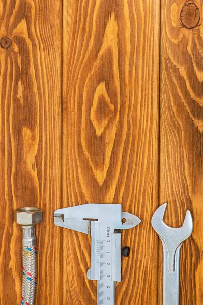 Necessary set of tools for plumbers on vintage wooden boards with space for advertising — Stock Photo, Image