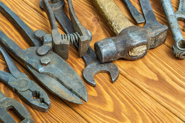 Old tools stacked after work on vintage wood background — Stock Photo, Image