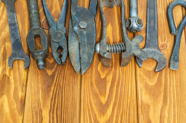 Old tools stacked after work on vintage wood background — Stock Photo, Image