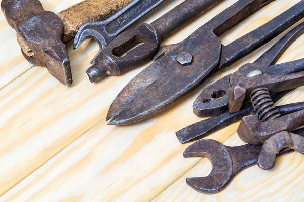 Many old tools stacked after work on wooden boards — Stock Photo, Image