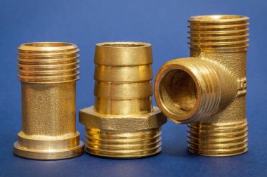 Three brass fittings is often used to connect for water and gas installations on blue background