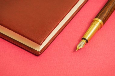 Not defteri ve yaldızlı kalem işadamı ile ofis hala kırmızı masa notlar için hazırlayın