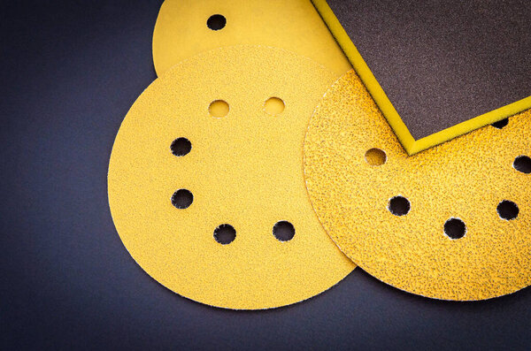 Set of yellow abrasive tools on black background. The wizard is used for grinding items