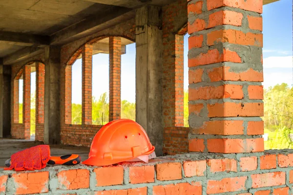 Protective helmets and gloves at home construction site are prepared before work