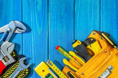 Mavi ahşap arka plandaki bir inşaatçı için profesyonel alet çantası ayrıca reklam için de kullanılacak