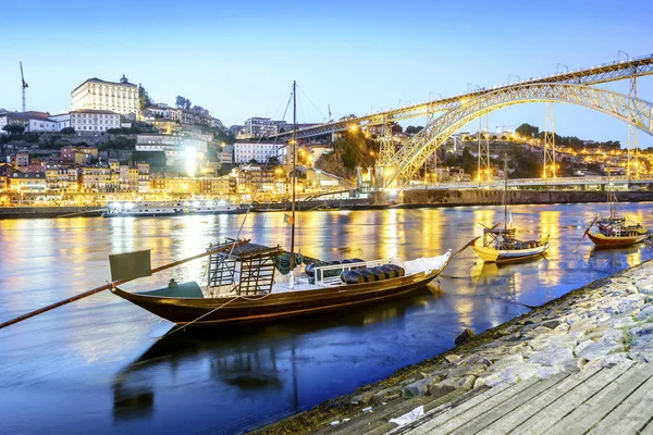 Downtown by Douro river with wine barrels on old boats, Porto, P