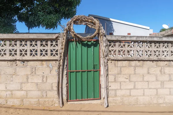 Wedding  decoration around green entrance door to regular house in Maputo, Mozambique