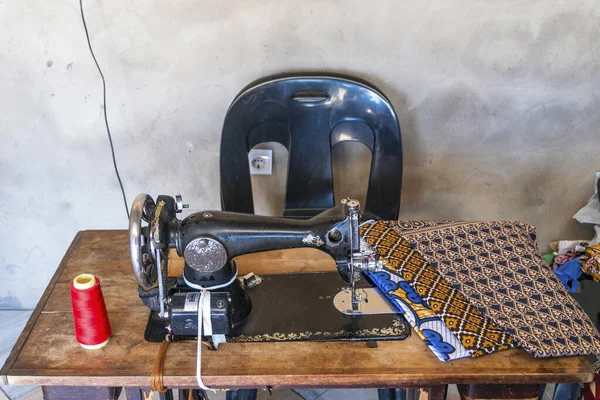 Sewing machine and African fabrics in seamstress workshop, Mozambique, Africa
