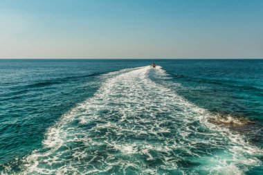 Budva, Karadağ yakınındaki bir sürat teknesi arkasında Adriyatik Denizi yüzeyinde bir izleme.