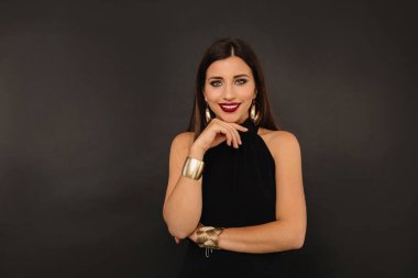 Siyah bluzlu, güzel beyaz bir bayan. Yüzü destekli ve ilgiyle bakıyor.. 