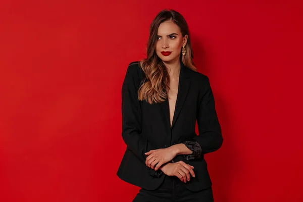 Beautiful woman with evening make up wearing black jacket posing over isolated red background. Birthday, Valentine's day, holiday — 스톡 사진