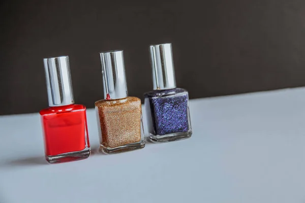 Colorful nail polish bottles on black and white