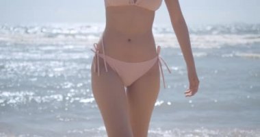 SLOW MOTION: Closeup body bikini sexy walking seaside beach slim perfect fit of young asian woman tan skin at tropical resting and relaxation travel lifestyle concept