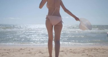 SLOW MOTION: Smiling Young bikini sexy asian woman playing freedom at seaside beach tropical resting and relaxation travel lifestyle concept