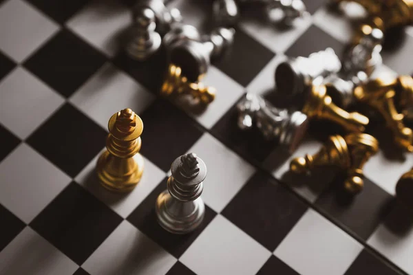 Gold and Silver Chess game king staying on chessboard,Business planing strong concept