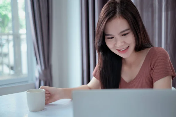 stock image Asian woman working from home with laptop computer self isolation from society to reduce risk, quarantine prevention coronavirus, covid-19 and study e-learing online education technology concept.