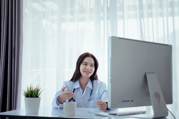 Asian doctor video conference with woman patient care discussing and consultant for medical coronavirus video call user interface healthcare online service remotely talking when quarantine at home.