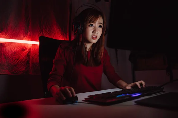 Young gamer play online with friends. Dark scene with gaming PC and lots of  RGB light Stock Photo - Alamy