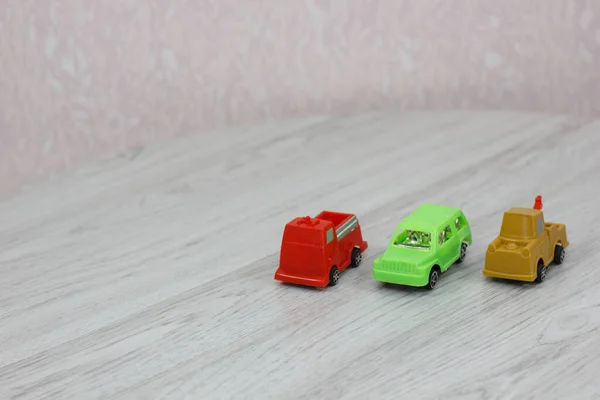 Colourful plastic toys on floor - cars. Kids toys.