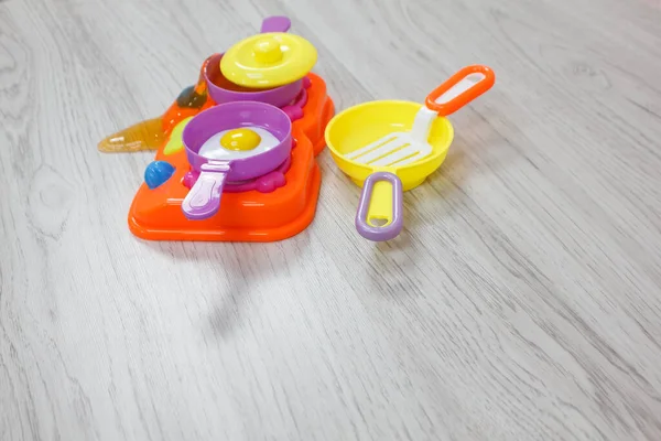 Plastic Kids toys collection on floor - utensil and cooking, food theme.