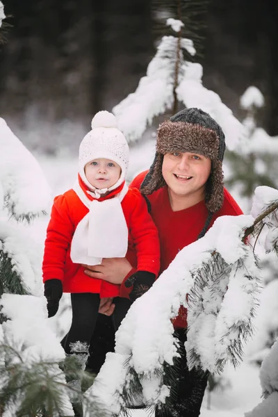 Portrait of happy little girl in red coat with dad having fun with snow in winter forest. girl playing with dad — Stock Photo, Image
