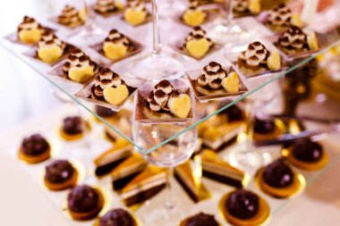 Düğün resepsiyonu için renkli masalar ve şekerlerle süslenmiş tatlı masaları bir parti için açık büfe şekerli tatlı masaları. Kekler, kekler, tatlılık. seçici odak