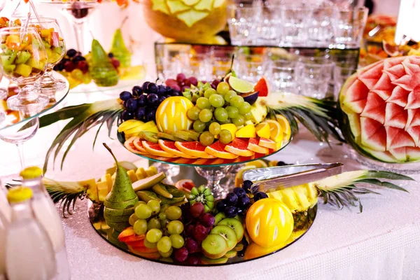 Fresh, exotic, organic fruits, light snacks in a plate on a buffet table. Assorted mini delicacies and snacks, restaurant food at event. Decorated delicious table for a party goodies. Royalty Free Stock Photos