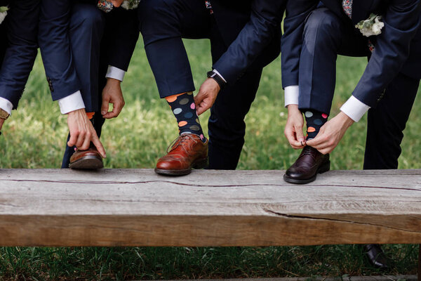stylish men's socks. Stylish suitcase, men's legs, multicolored socks and new shoes. Concept of style, fashion, beauty and vacation