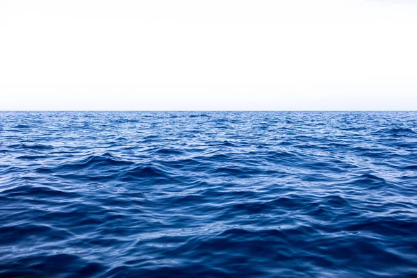 Sakin deniz okyanus ve mavi gökyüzü arka plan — Stok fotoğraf