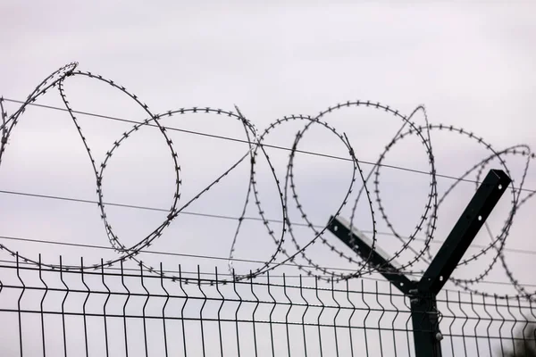 Barbed wire on the sky background. selective focus. metal wire