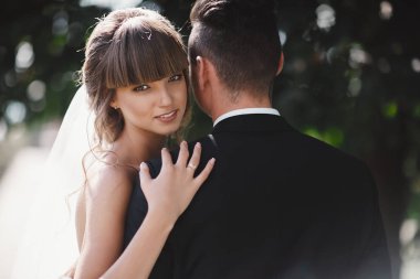 portrait of happy stylish couple on their wedding day outdoors